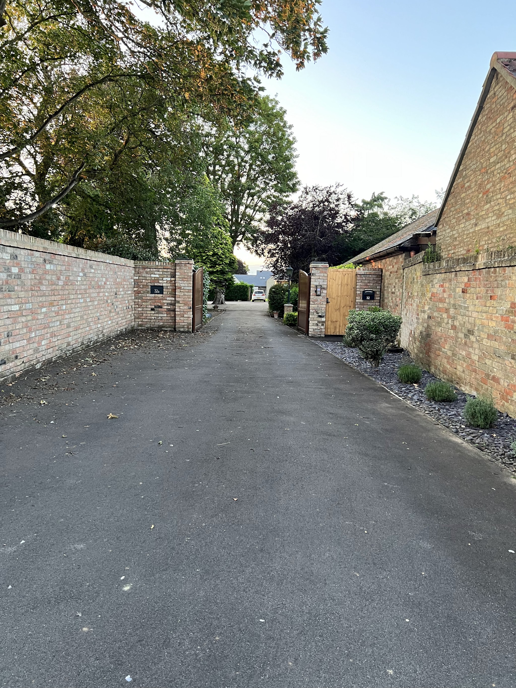 The drive between old brick walls leading to the studio