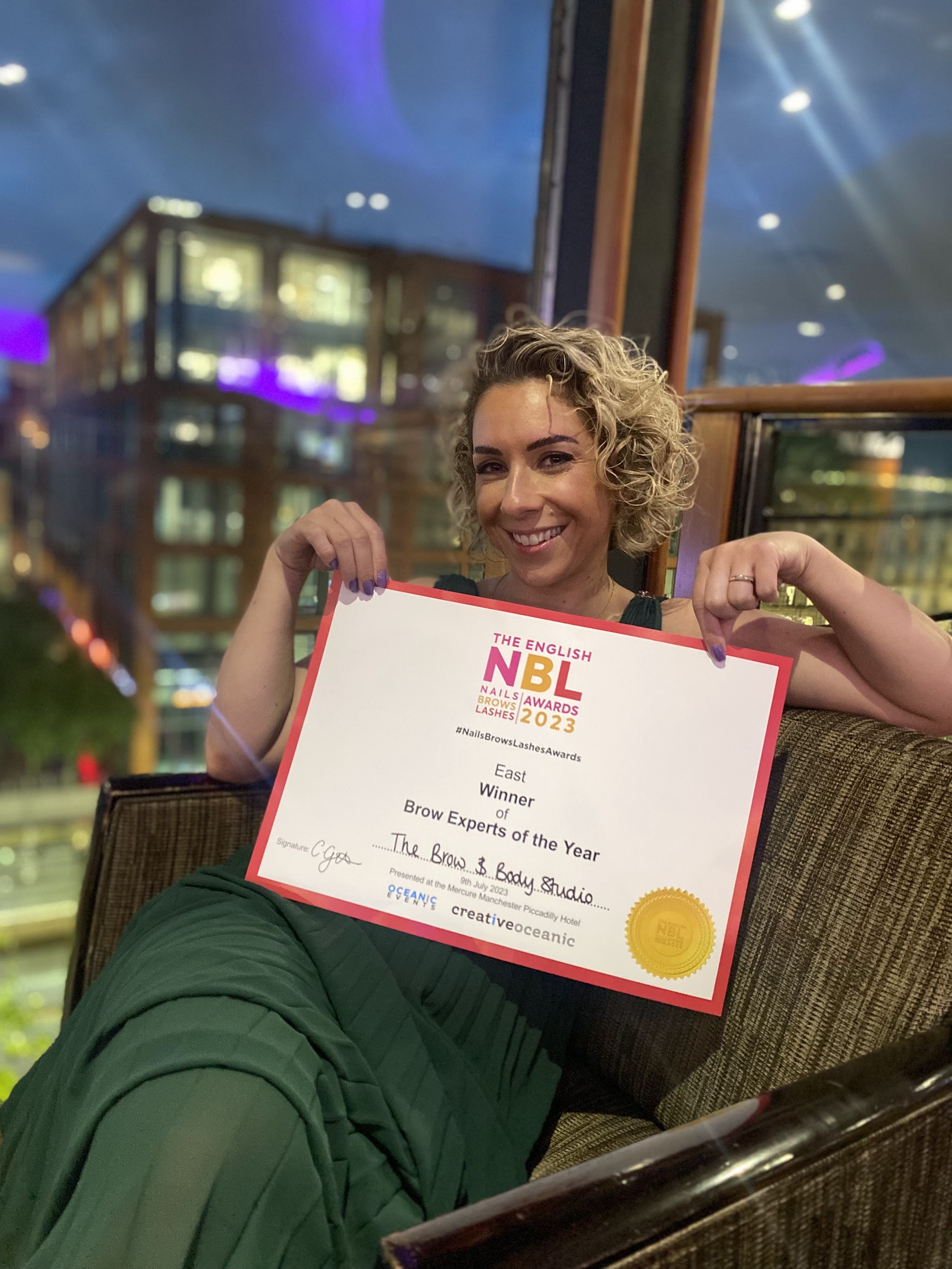 Helen holding her NBL Awards 2023 certificate, East Winner of Brow Experts of the Year